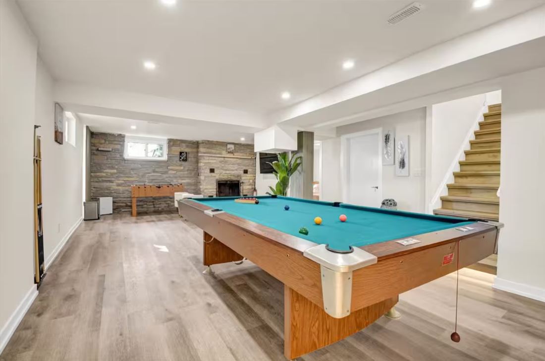 Lower-level games room with pool table and foosball